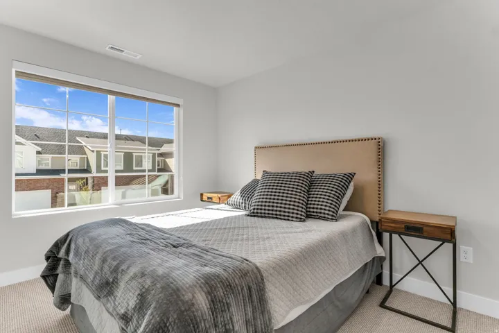 Neutral wall paint, window with grid panes, wall-to-wall carpeting