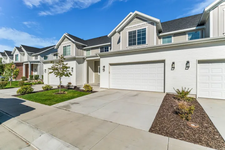 White brick and siding exterior with dark shingle roofing