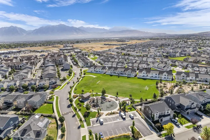 Expansive residential development with a large central green space, surrounded by numerous single-family homes and multi-story residential buildings