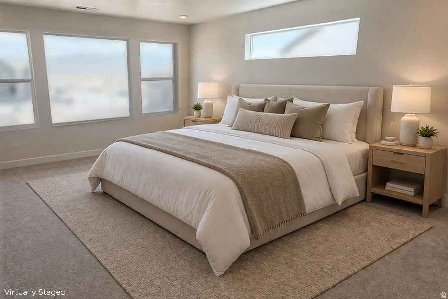 Spacious Primary Bedroom featuring multiple large windows, a high horizontal window, recessed ceiling lighting, and wall-to-wall carpeting