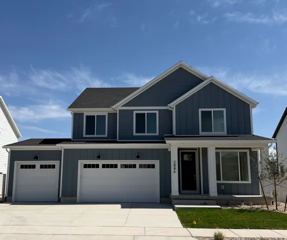 Contemporary two-story exterior with dark blue siding and white trim