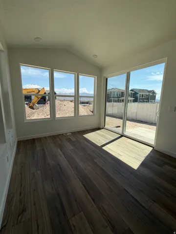 Wood-finish flooring with a multi-pane window and sliding glass door