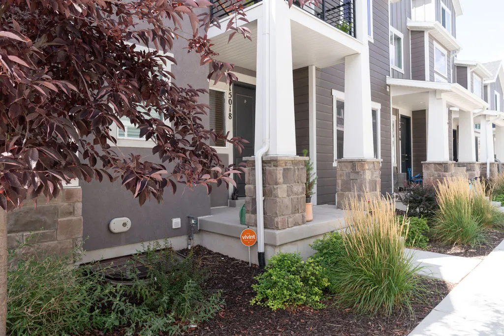 Exterior featuring siding, stone accents, and a covered porch