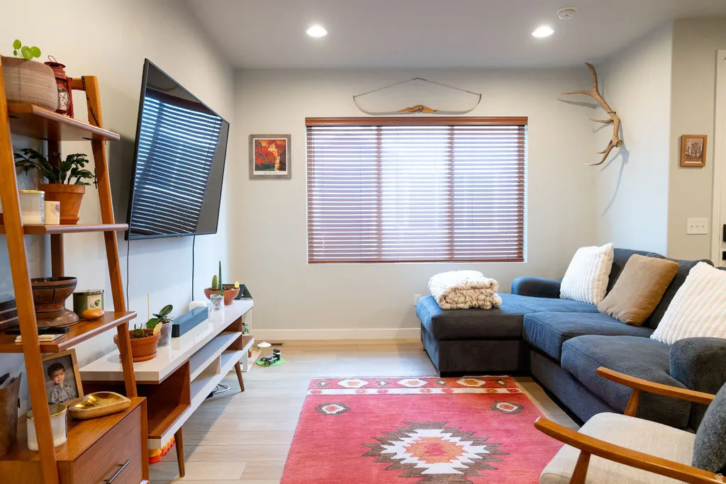 Recessed lighting, wood-finish window blinds, and light wood-finish flooring