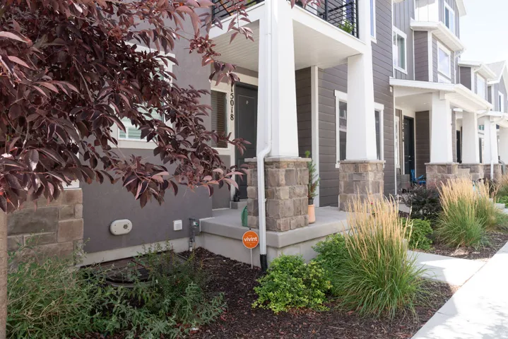 Exterior featuring siding, stone accents, and a covered porch
