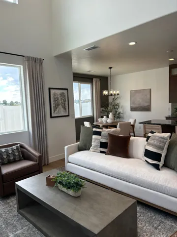 Vaulted ceiling, recessed lighting, wood-finish flooring, multiple windows, and open concept design