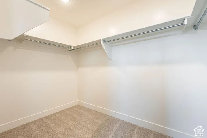 Recessed lighting, light-toned walls, and carpet flooring