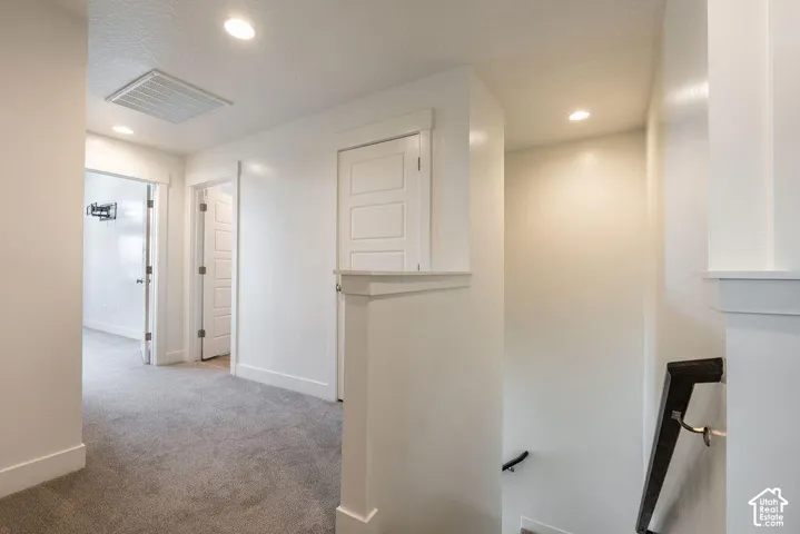 Hallway with recessed lighting, carpet flooring, and white paneled doors