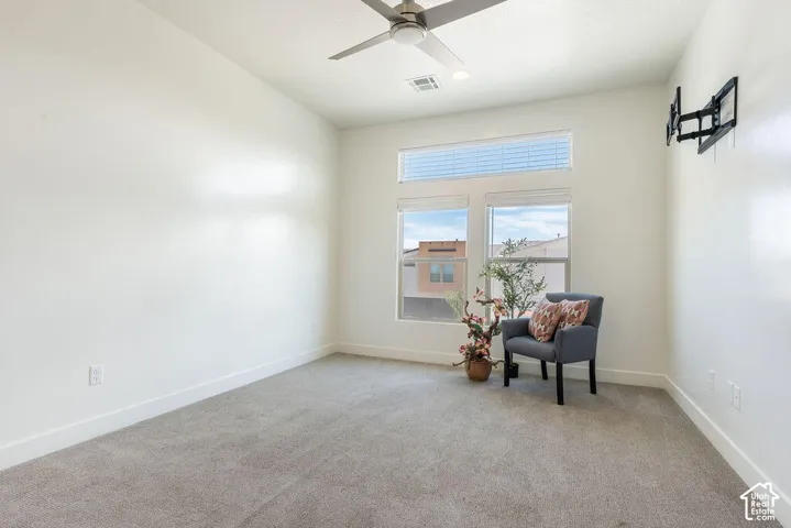 High ceilings, recessed lighting, ceiling fan, carpeting, and multiple windows with blinds