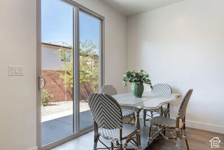 Sliding glass door leading to a concrete patio, featuring a gravel area and a block wall perimeter