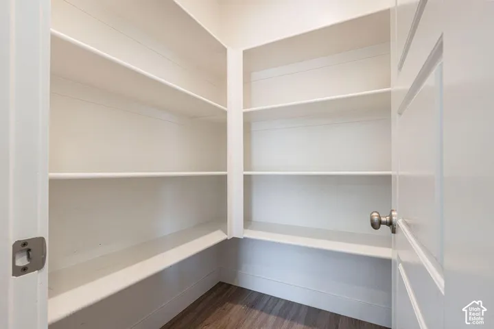 Built-in white shelving system with wood-finish flooring