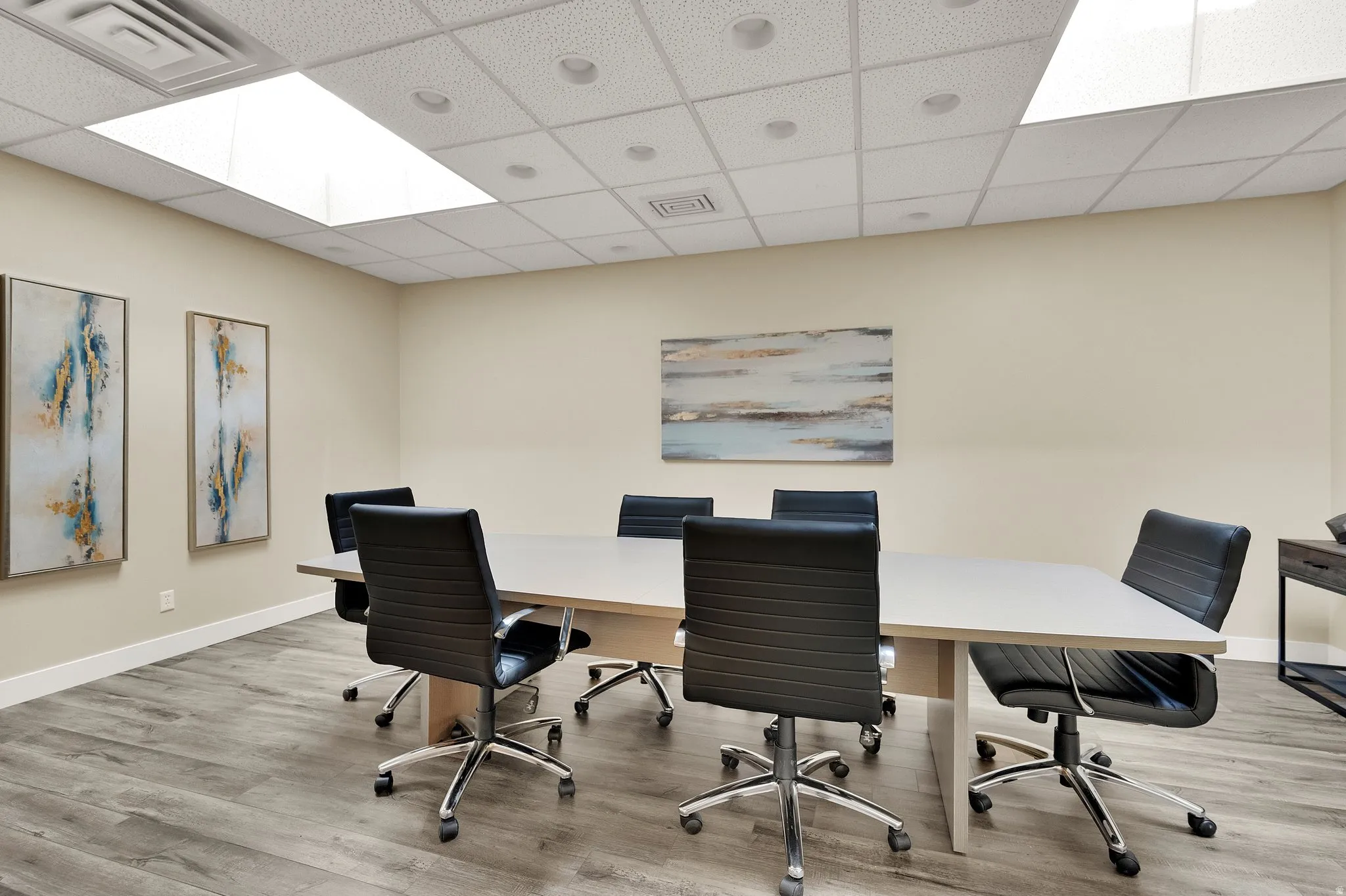 Recessed ceiling lighting, dropped ceiling, wood-finish flooring, and light-colored walls