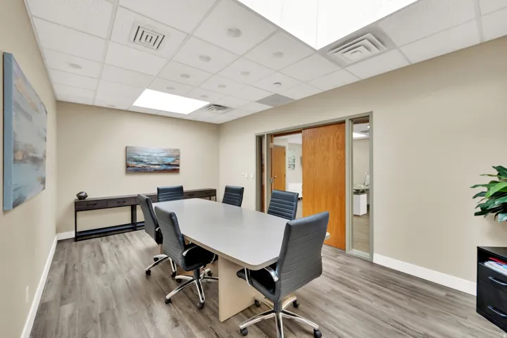 Recessed lighting, wood-finish flooring, drop ceiling, and sliding wood door