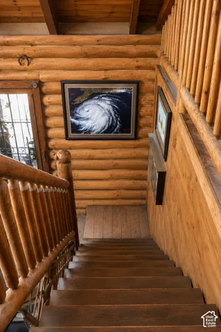 Rustic wood stairway featuring wood-finish treads and risers