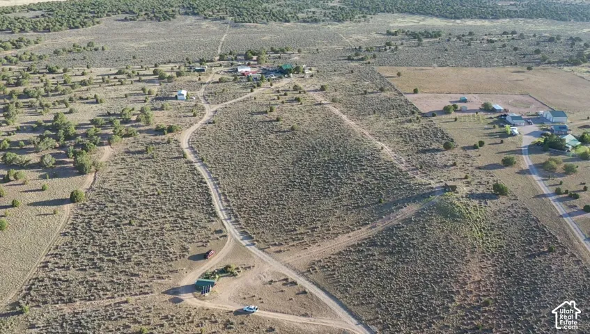 Expansive undeveloped land featuring natural terrain and established dirt roads