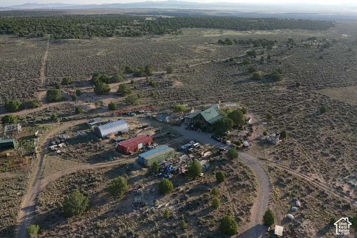 Expansive desert landscape with multiple outbuildings and established structures