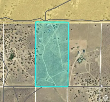 Property Map. An aerial view of the property outlined in blue, indicating its boundaries relative to surrounding land parcels and infrastructure