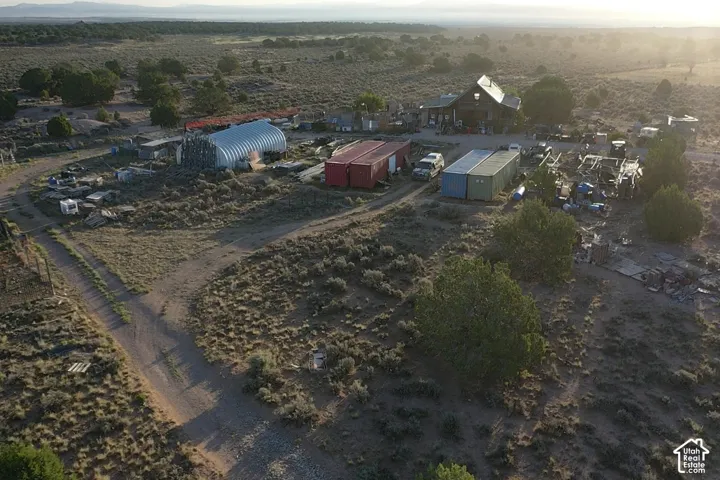 Property featuring a main residence, multiple outbuildings, and expansive natural terrain