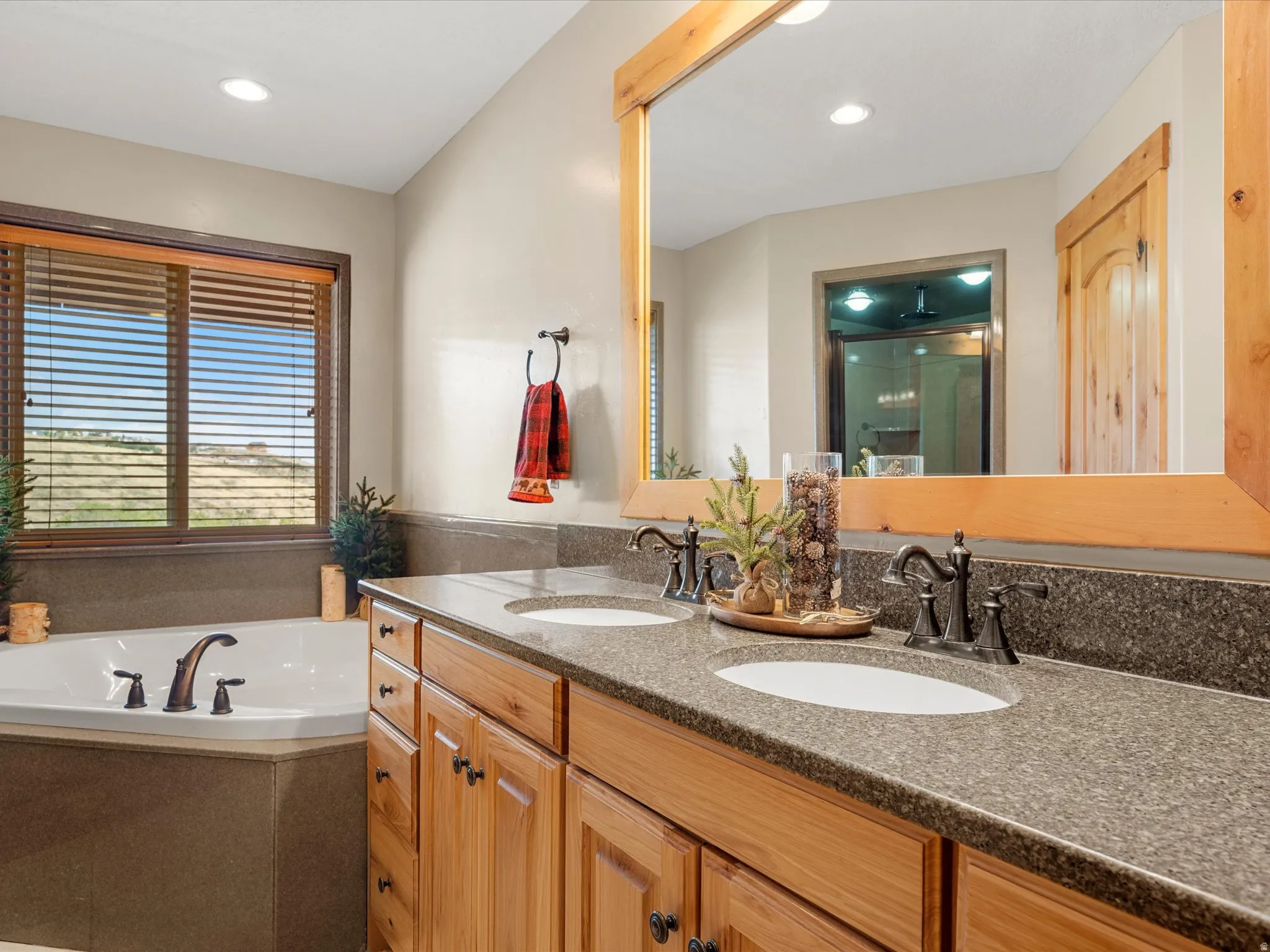 Dual vanity with wood cabinetry and stone countertops