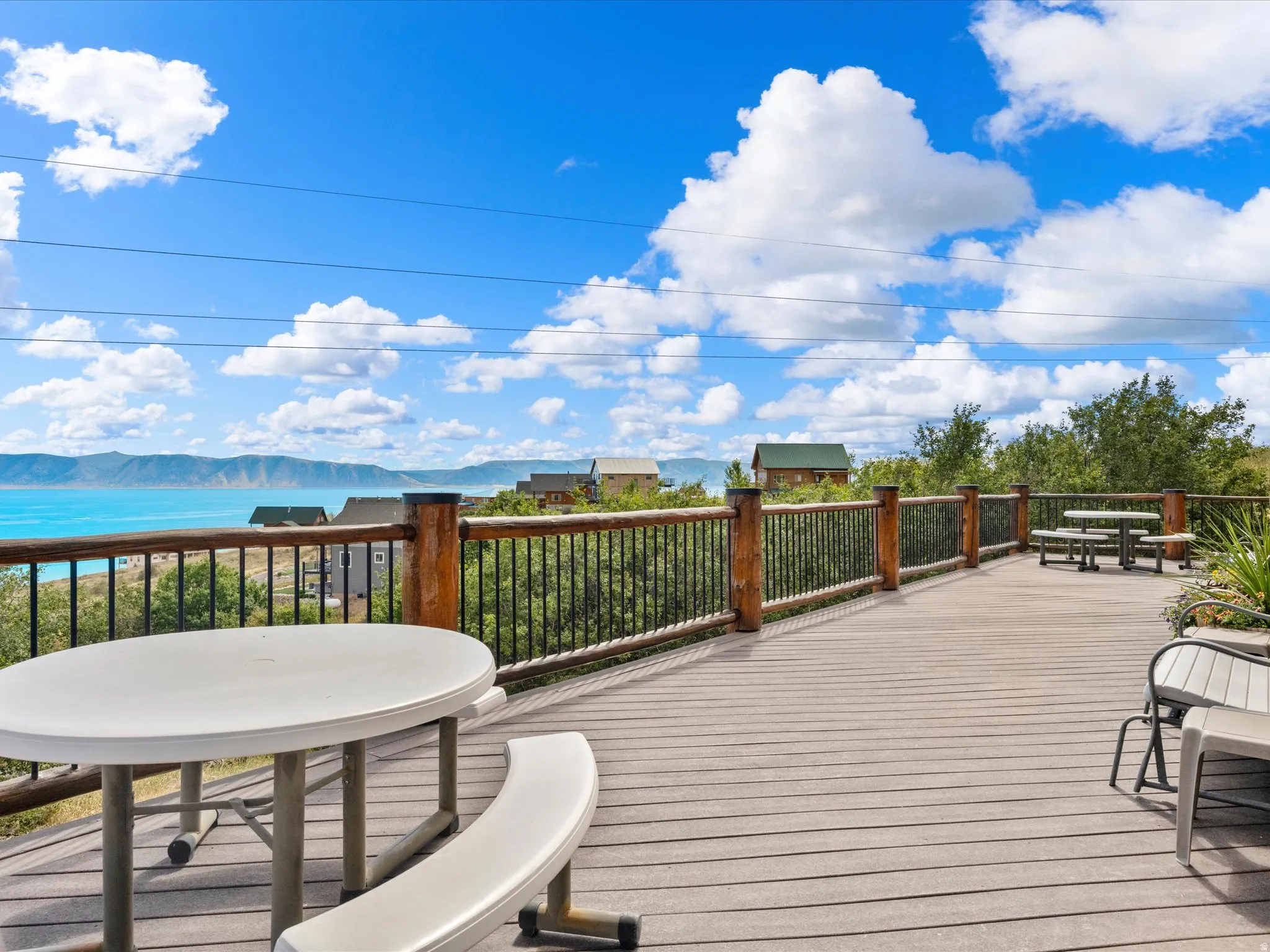 Expansive outdoor deck with composite decking, featuring a wood and metal railing