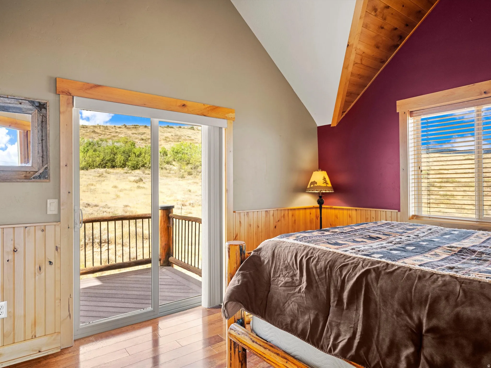 Hardwood flooring complemented by wood paneling and a vaulted wood-finish ceiling