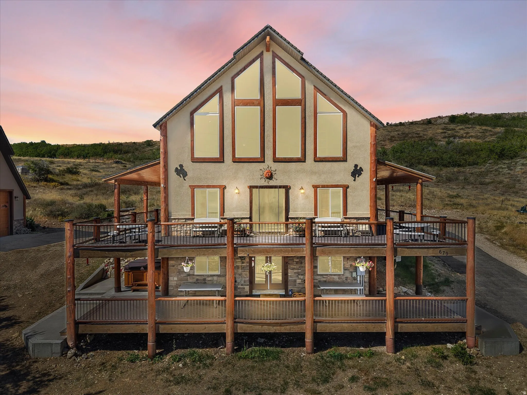 Multi-level dwelling with a gabled roofline and a stucco exterior