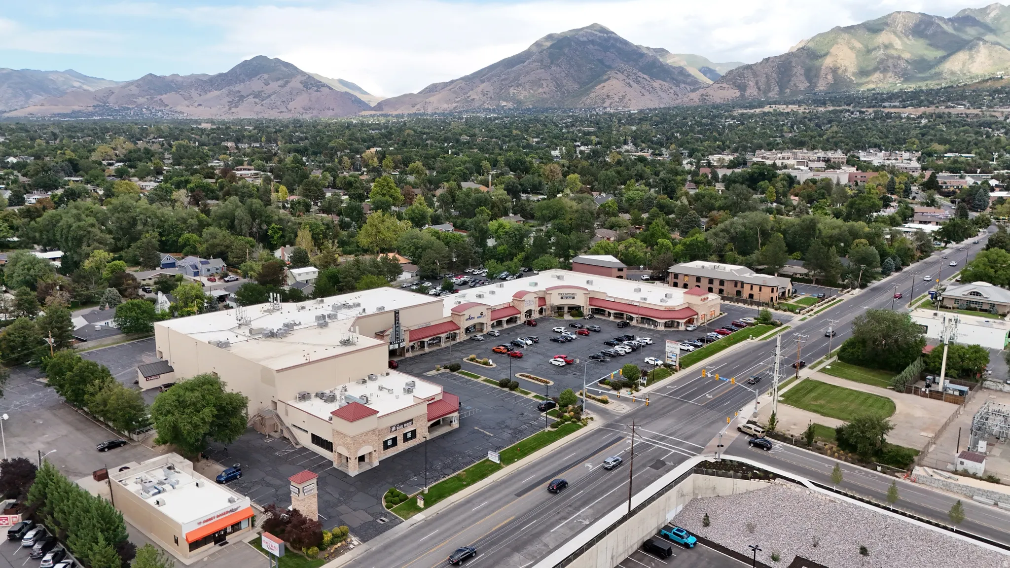 Commercial property with extensive parking, direct road frontage, and multiple commercial buildings