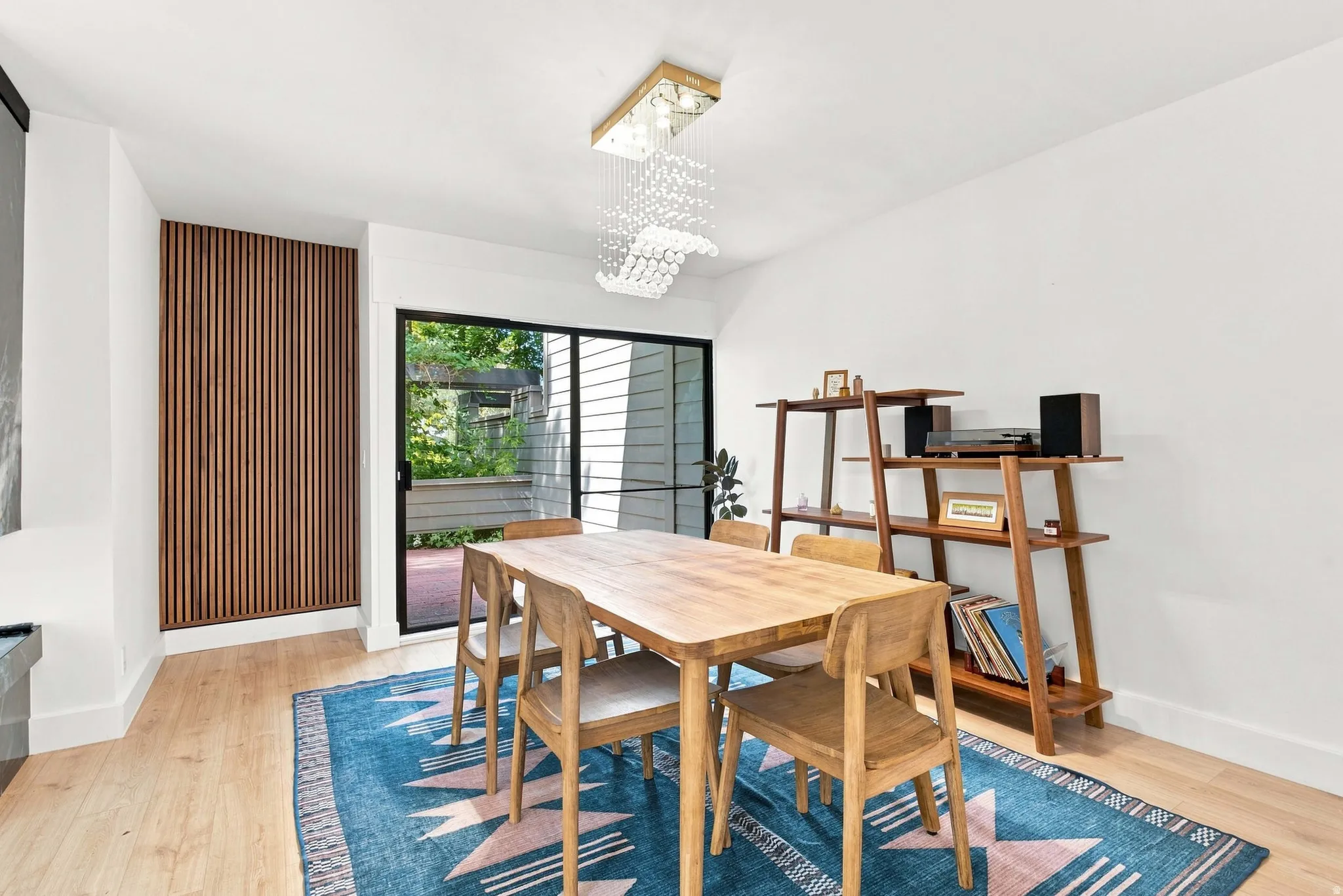 Light wood-finish flooring, white walls, and a sliding glass door