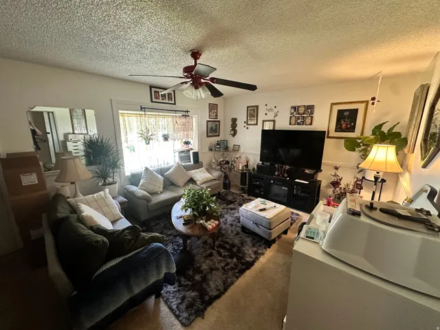 Wall-mounted ceiling fan, built-in window and window trim, and wall-to-wall carpeting