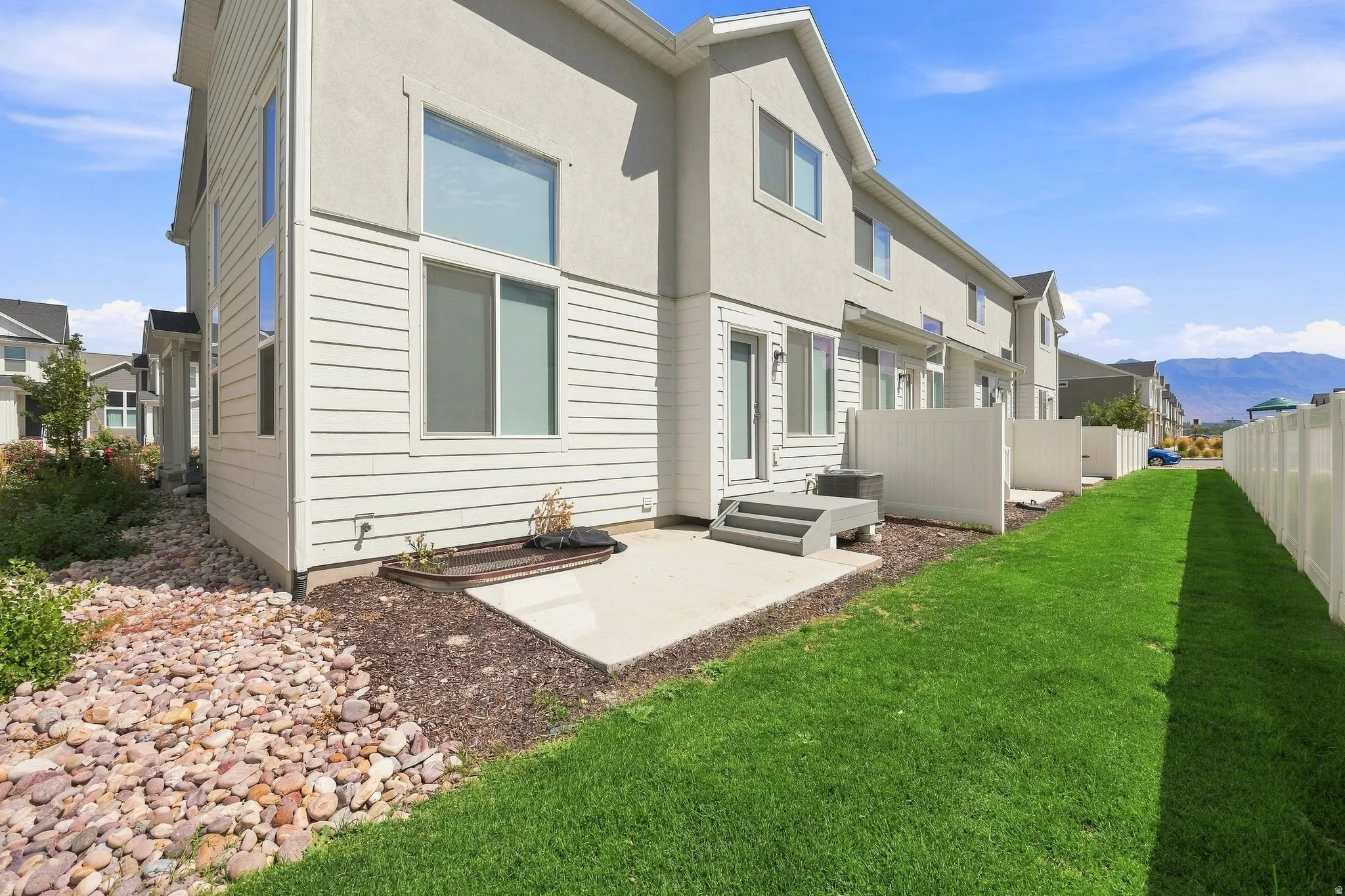 Exterior featuring stucco and horizontal siding, with a concrete patio and steps