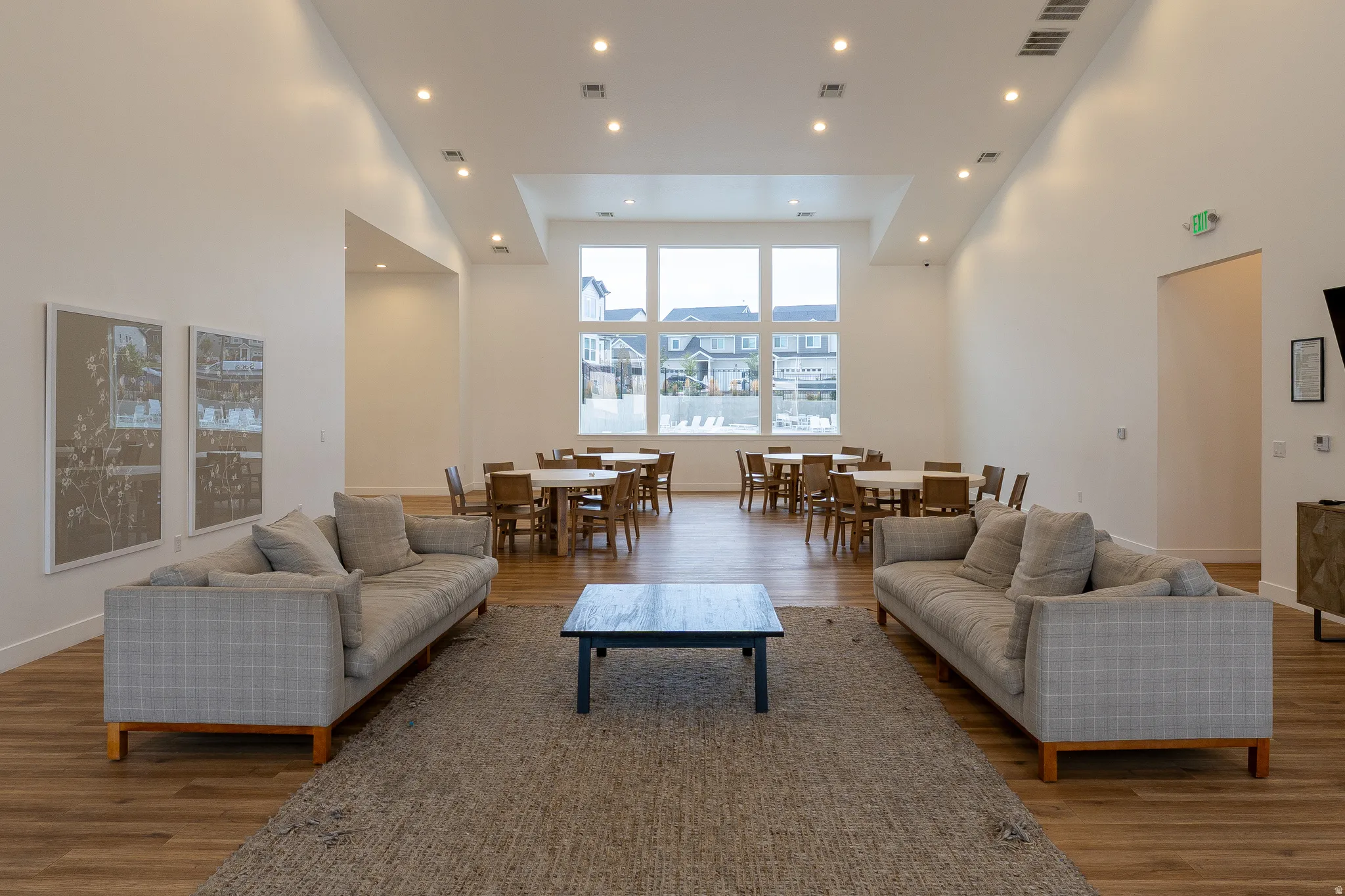 Expansive room with high ceilings, recessed lighting, and wood-finish flooring