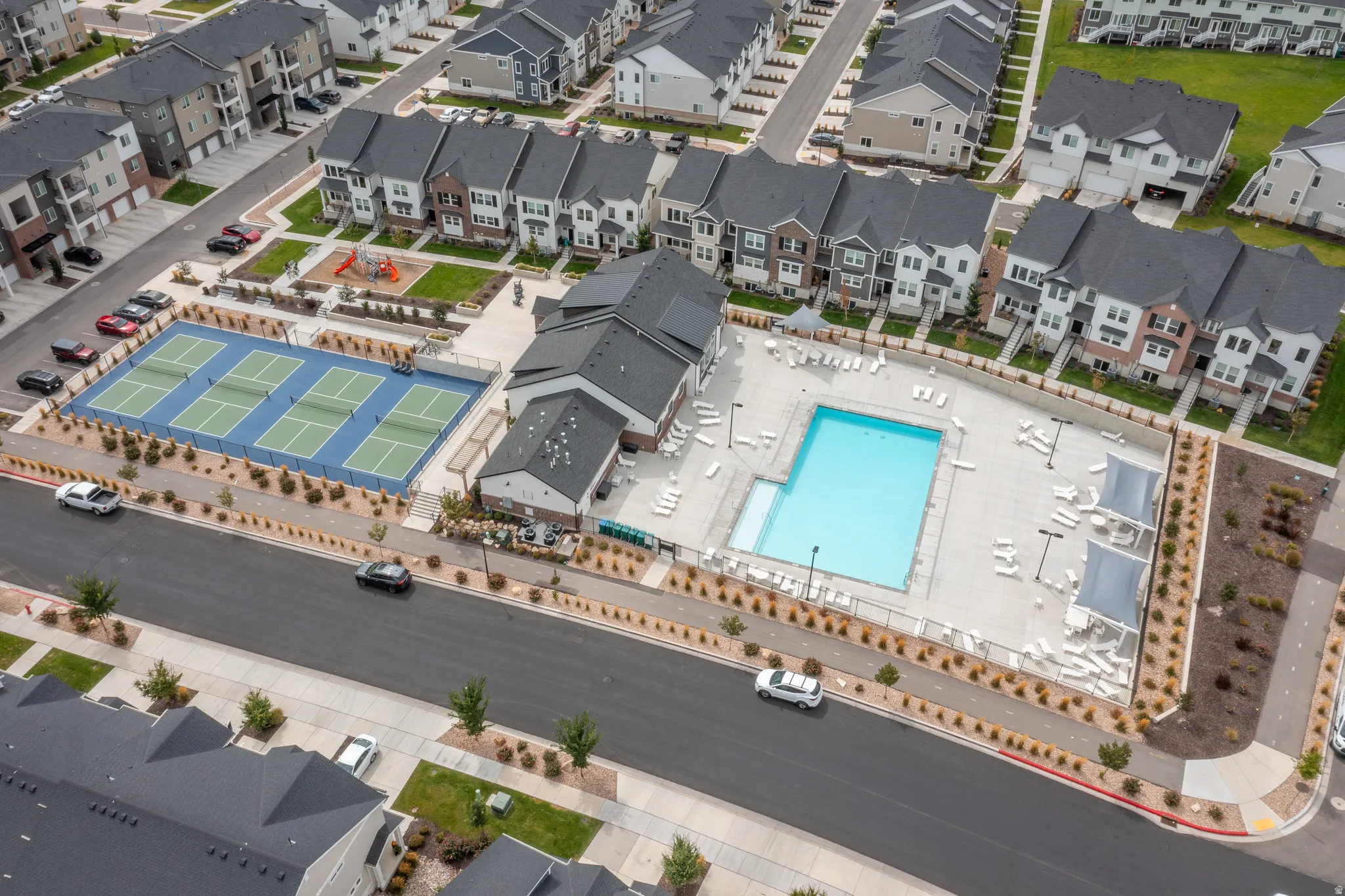 Community amenities featuring a swimming pool, multiple tennis courts, and a playground