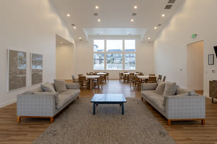 Expansive room with high ceilings, recessed lighting, and wood-finish flooring