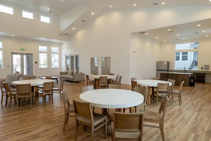 Vaulted ceilings, wood-finish flooring, recessed lighting, and multiple large windows