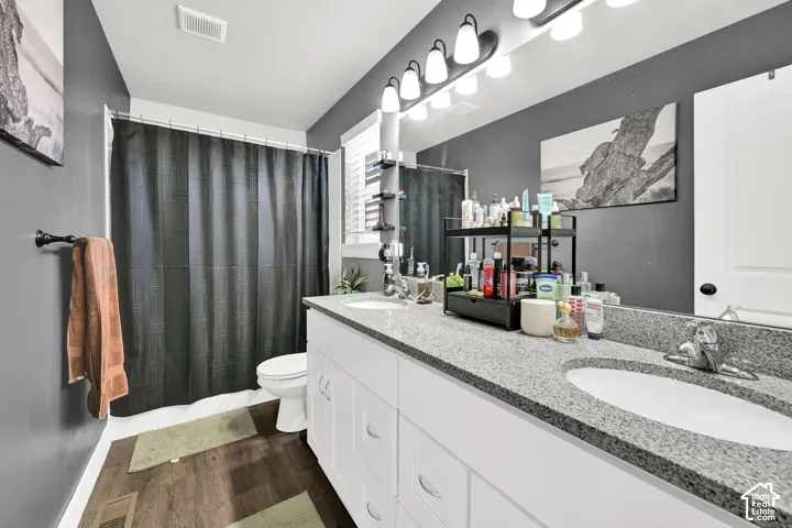 Main Bathroom upstairs. Dual vanity with integrated sinks, granite-finish countertop, and white cabinetry