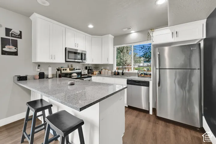 White shaker cabinetry paired with stainless steel appliances