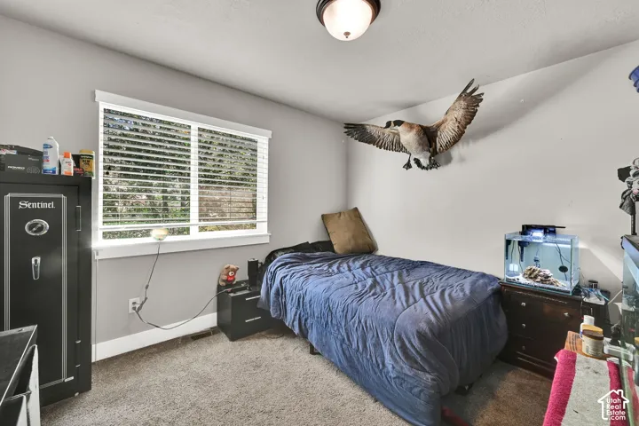 3rd Bedroom. Window with horizontal blinds, neutral wall paint, and ceiling-mounted light fixture