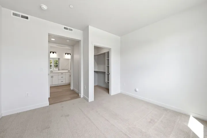 Carpeted flooring, recessed lighting, and a built-in closet with shelving