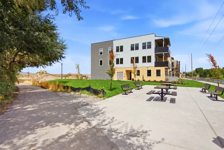 Concrete patio with multiple picnic tables and benches