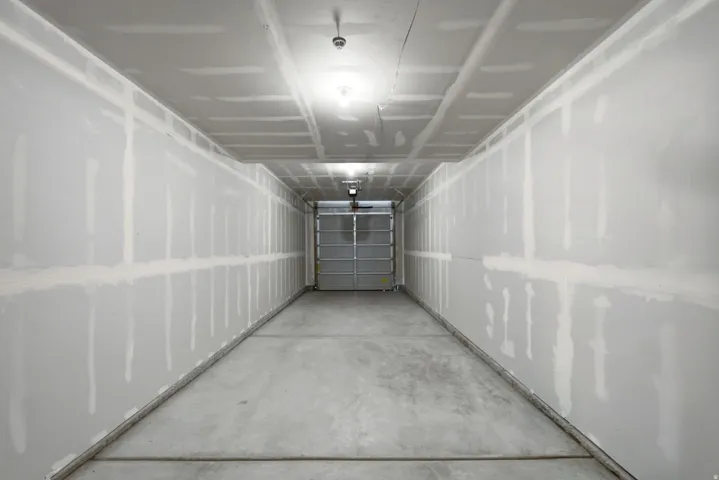 Concrete flooring and unfinished drywall walls