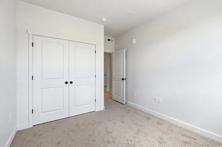 Neutral wall color, light-toned carpet, and white trim
