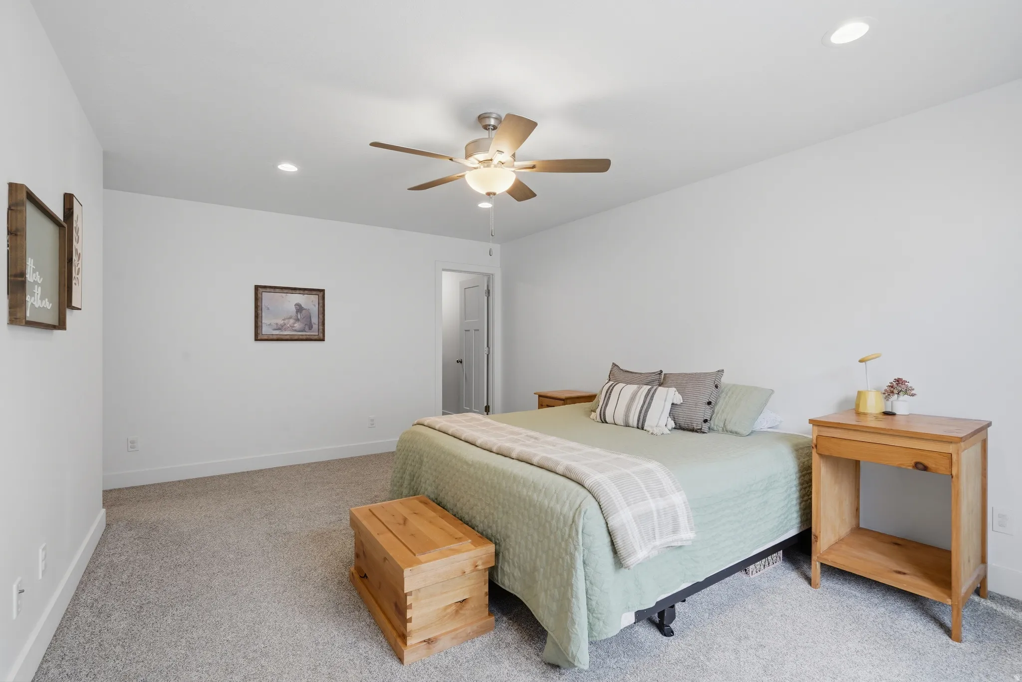 Recessed lighting, ceiling fan, and light gray carpeting