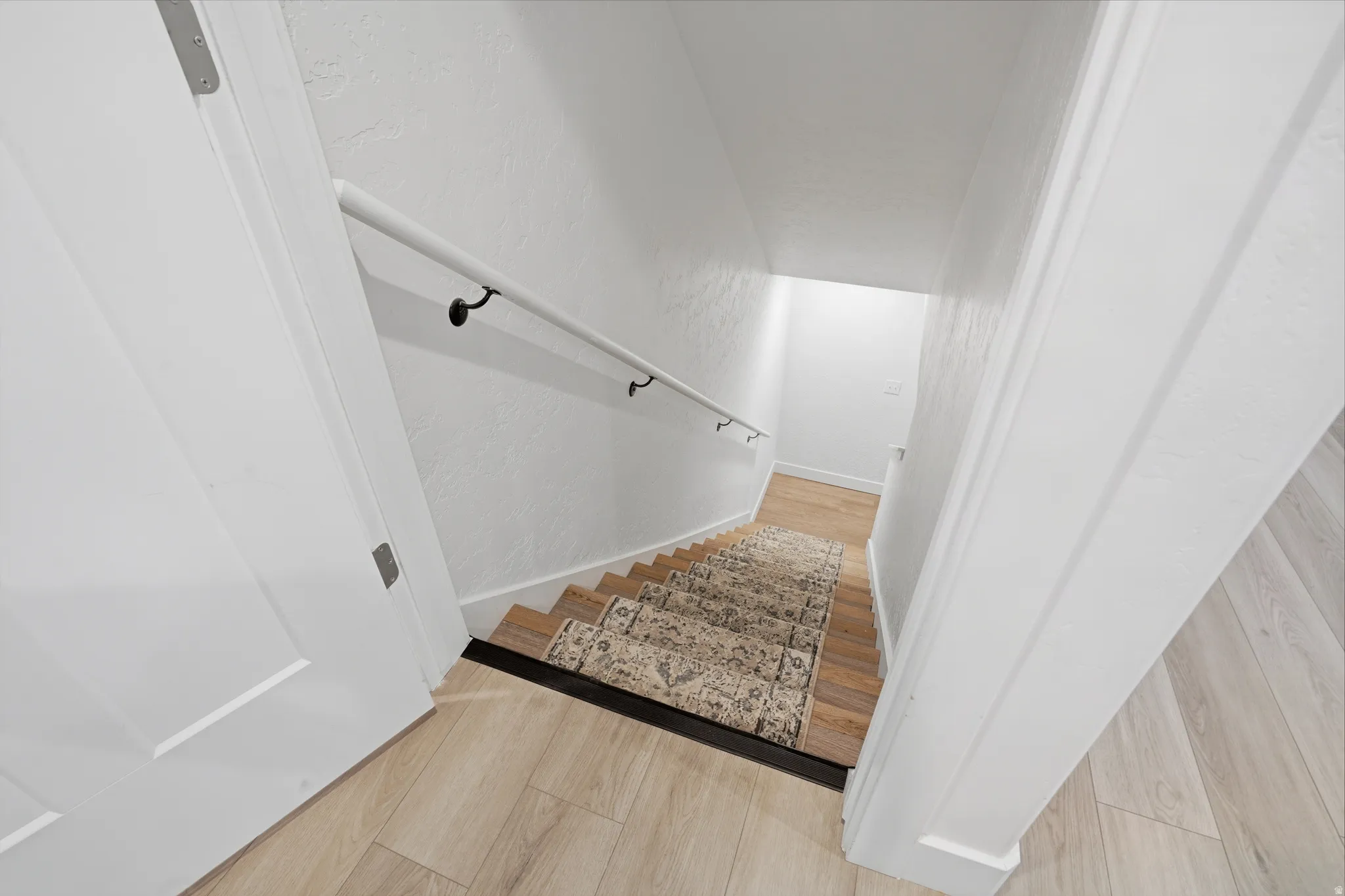 Light wood-finish flooring with a contrasting dark stair nosing