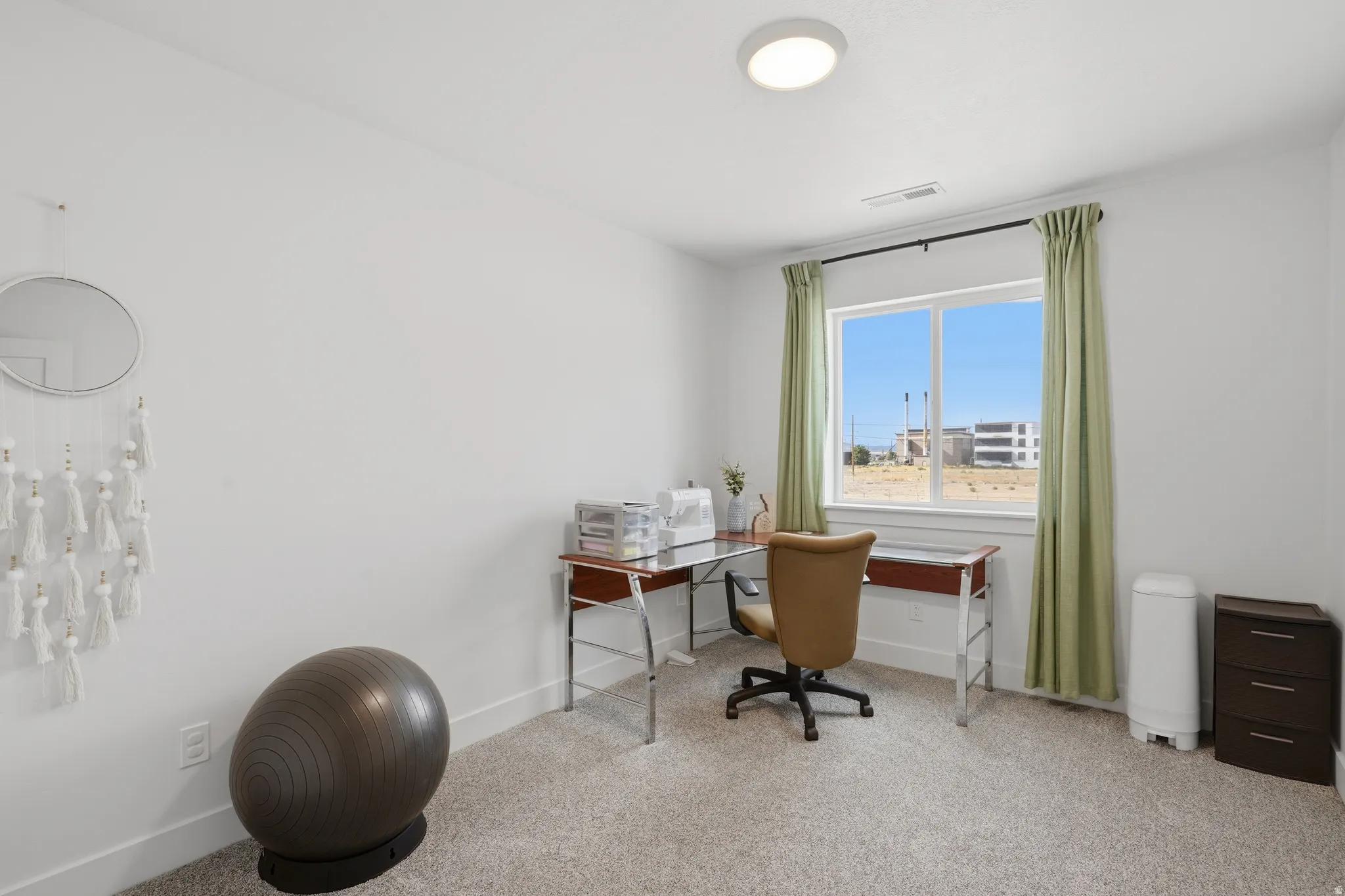 Recessed lighting, large window, and light-toned carpeting