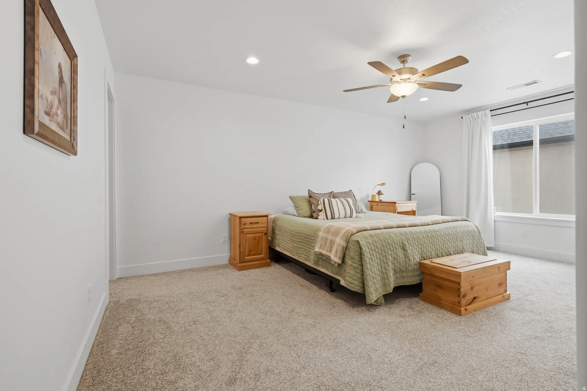 Recessed lighting, ceiling fan with integrated light, carpeted flooring, large window, and white trim