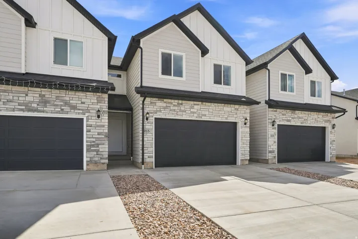 Contemporary exterior featuring stone veneer and vertical siding accents