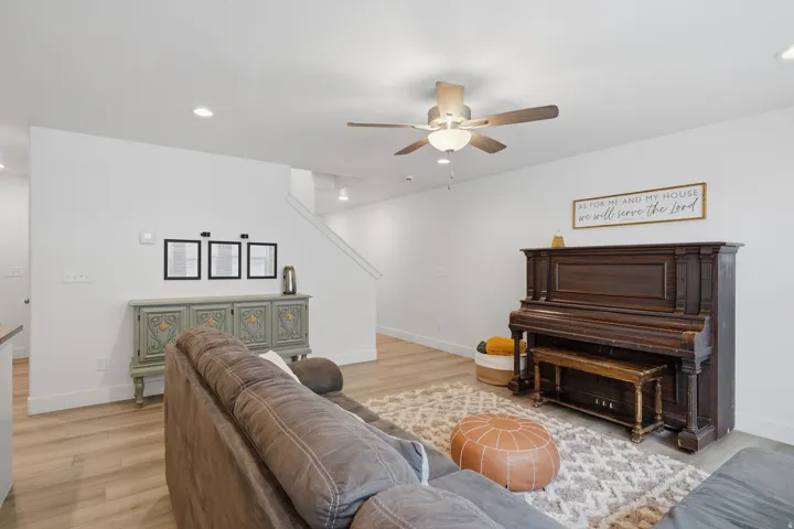 Recessed ceiling lighting, wood-finish flooring, and a ceiling fan with integrated lighting