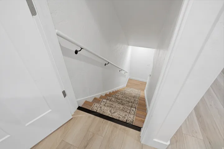 Light wood-finish flooring with a contrasting dark stair nosing