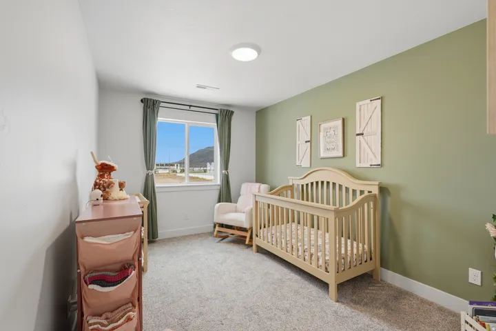 Wall-to-wall carpeting with light wall tones and a single accent wall