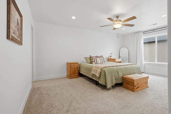 Recessed lighting, ceiling fan with integrated light, carpeted flooring, large window, and white trim